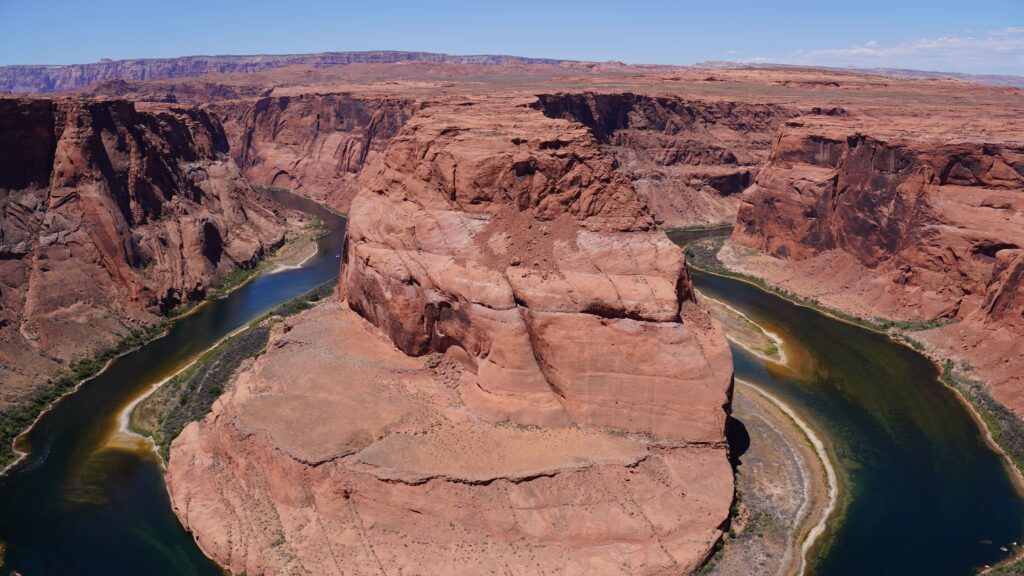 Panoramic view of Horseshoe Bend and Colorado River with protective railings at the fenced viewing platform, accessible and stroller friendly trail in Page Arizona Panoramic view of Horseshoe Bend and Colorado River with protective railings at the fenced viewing platform, accessible and stroller friendly trail in Page Arizona